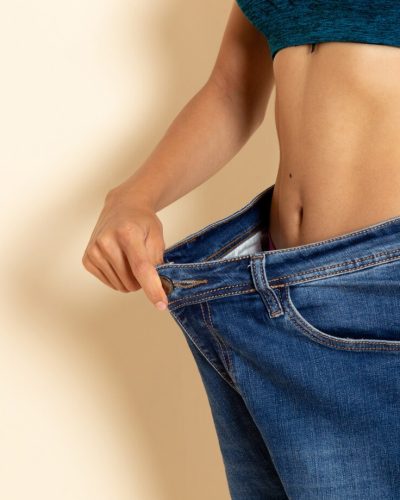 front-view-young-female-with-fit-body-shirt-jeans-white-wall_140725-59187